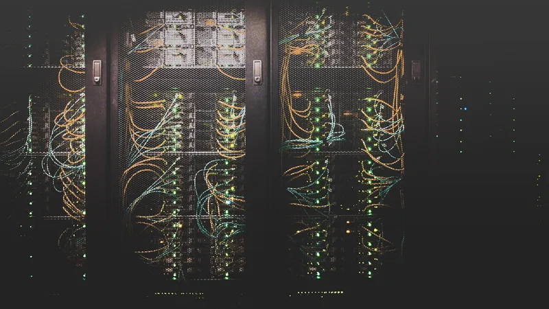 Server infrastructure with network cabling, illustrating the control and security trade-offs between SaaS and self-hosted control panels